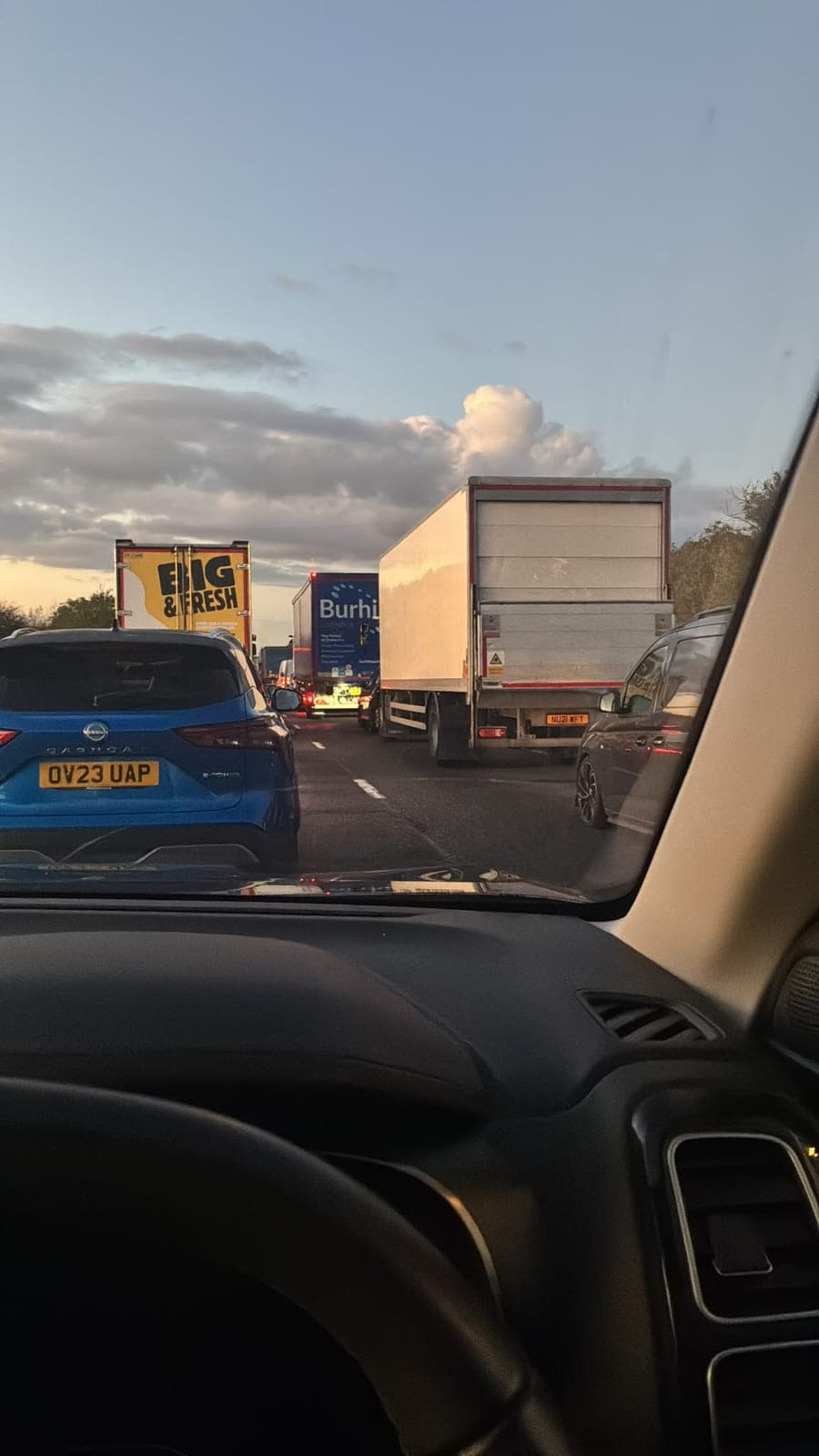Stationary traffic and lorries queuing ahead on the A1 at dusk